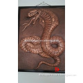 large snake sculpture wall relief